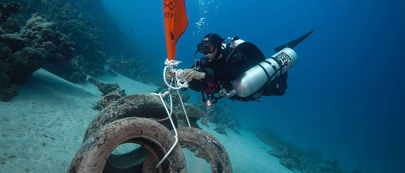 Ghost Diving – Diver recovers tyres with lift bag from ocean floor in Dahab Ghost Diving - Diver recovers tyres with lift bag from ocean floor in Dahab