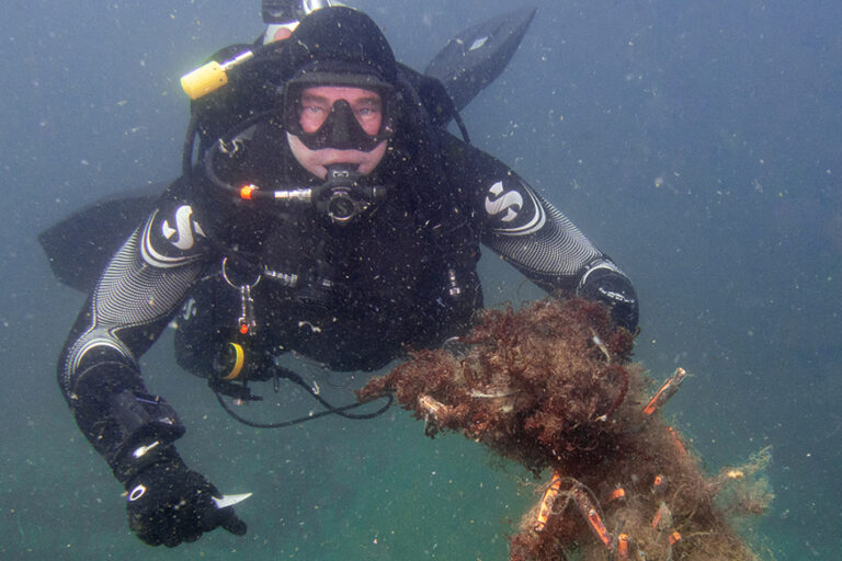 Ghost Diving - Diver from chapter in Hong Kong with junk from the ocean floor